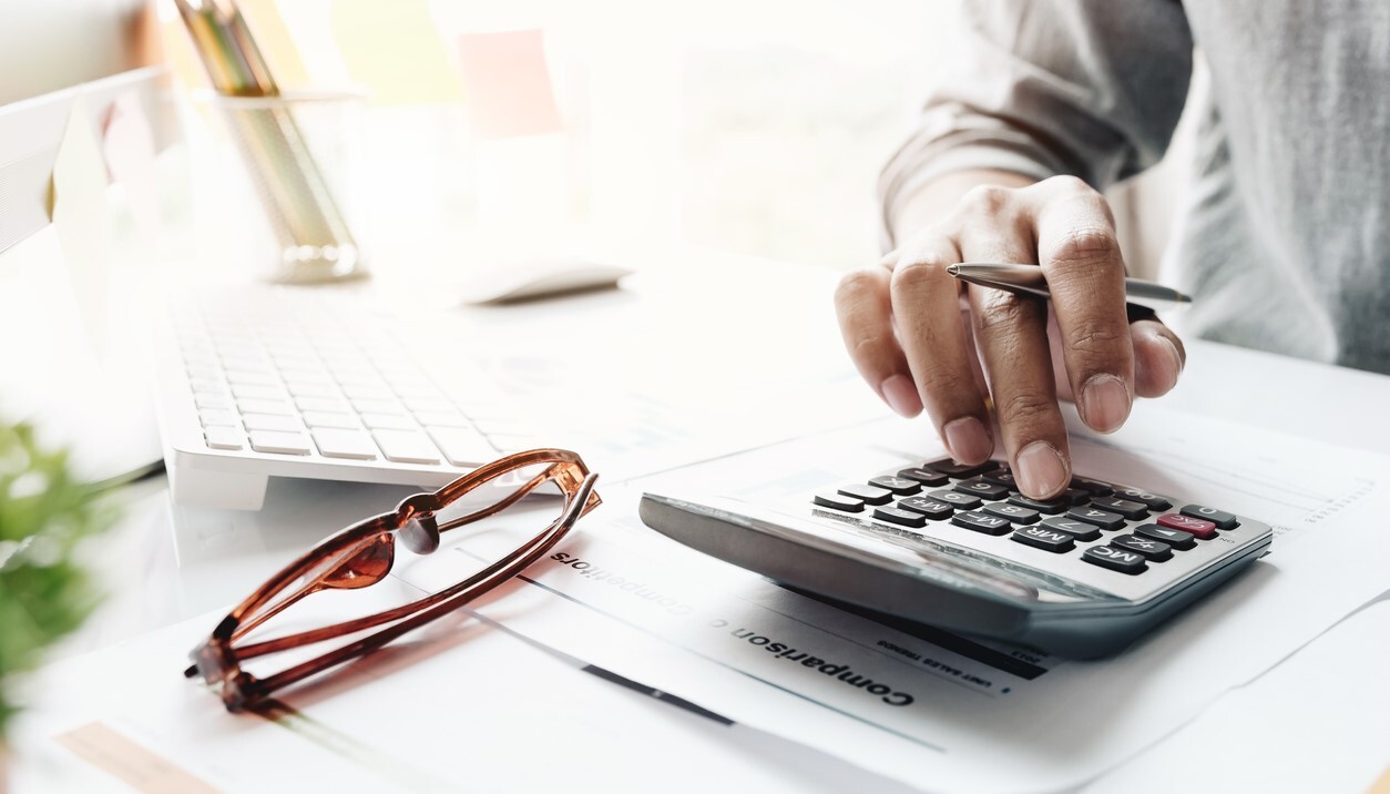 person typing on a calculator