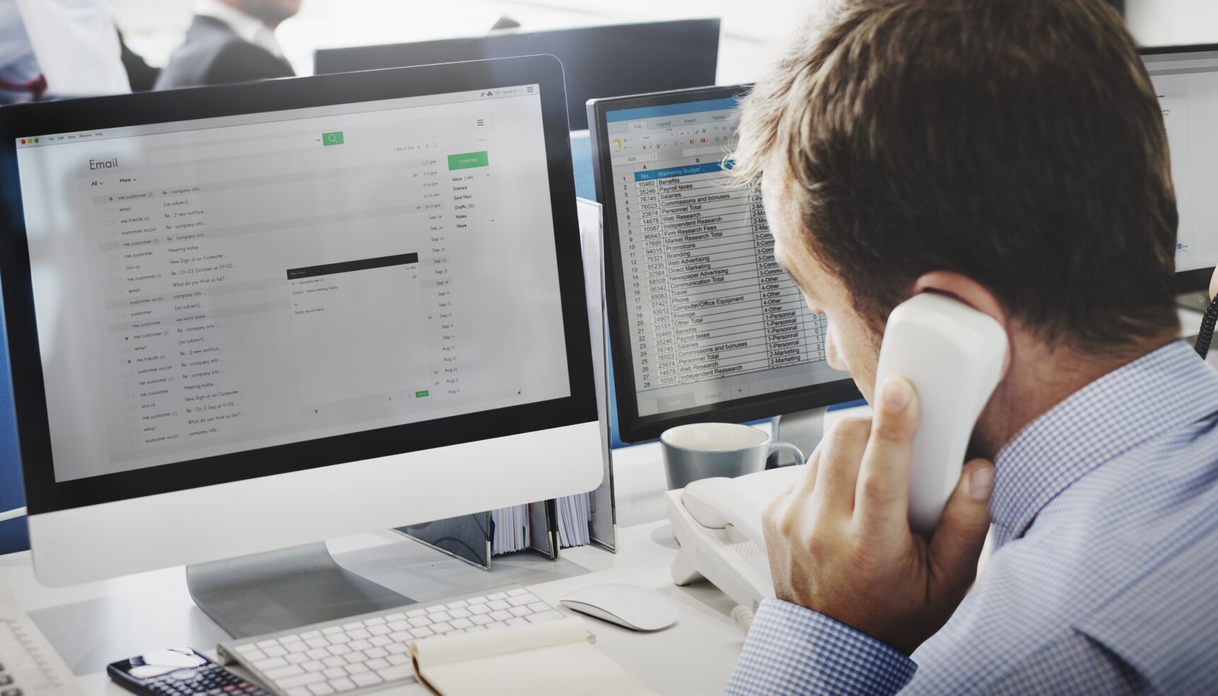 man on the phone at a computer